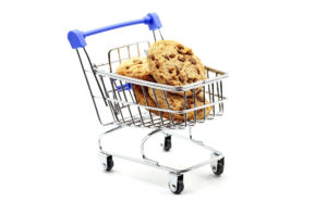 A supermarket trolley or shopping cart with chocolate cookies